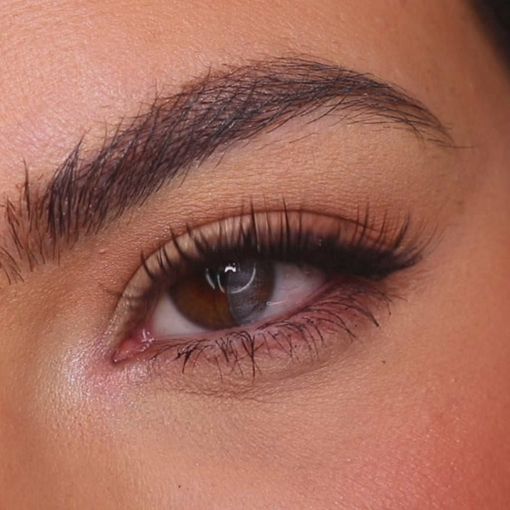 Model wearing EyeCandys Desire Grey colored contact lenses, showcasing a soft grey eye transformation with close-up views, natural movement, and a natural-looking cool-toned effect on brown eyes.