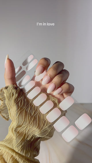  Video demonstrating the application of EyeCandys Peach Latte Gel Nail Stickers with a white and peach ombre design. Watch the easy step-by-step process for achieving trendy, long-lasting spring nails with a 7-free, allergy-friendly formula. Cures in sunlight in just 5-10 minutes, no UV lamp needed for a flawless, chic manicure.