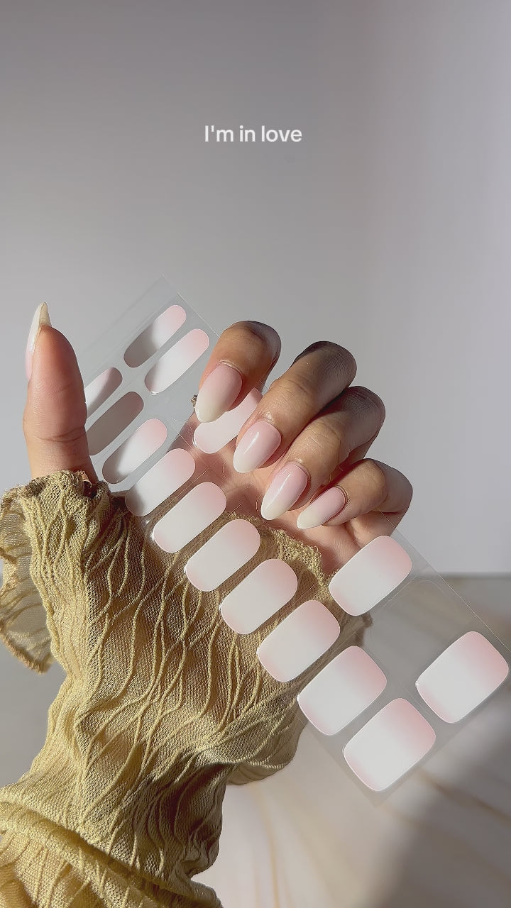  Video demonstrating the application of EyeCandys Peach Latte Gel Nail Stickers with a white and peach ombre design. Watch the easy step-by-step process for achieving trendy, long-lasting spring nails with a 7-free, allergy-friendly formula. Cures in sunlight in just 5-10 minutes, no UV lamp needed for a flawless, chic manicure.