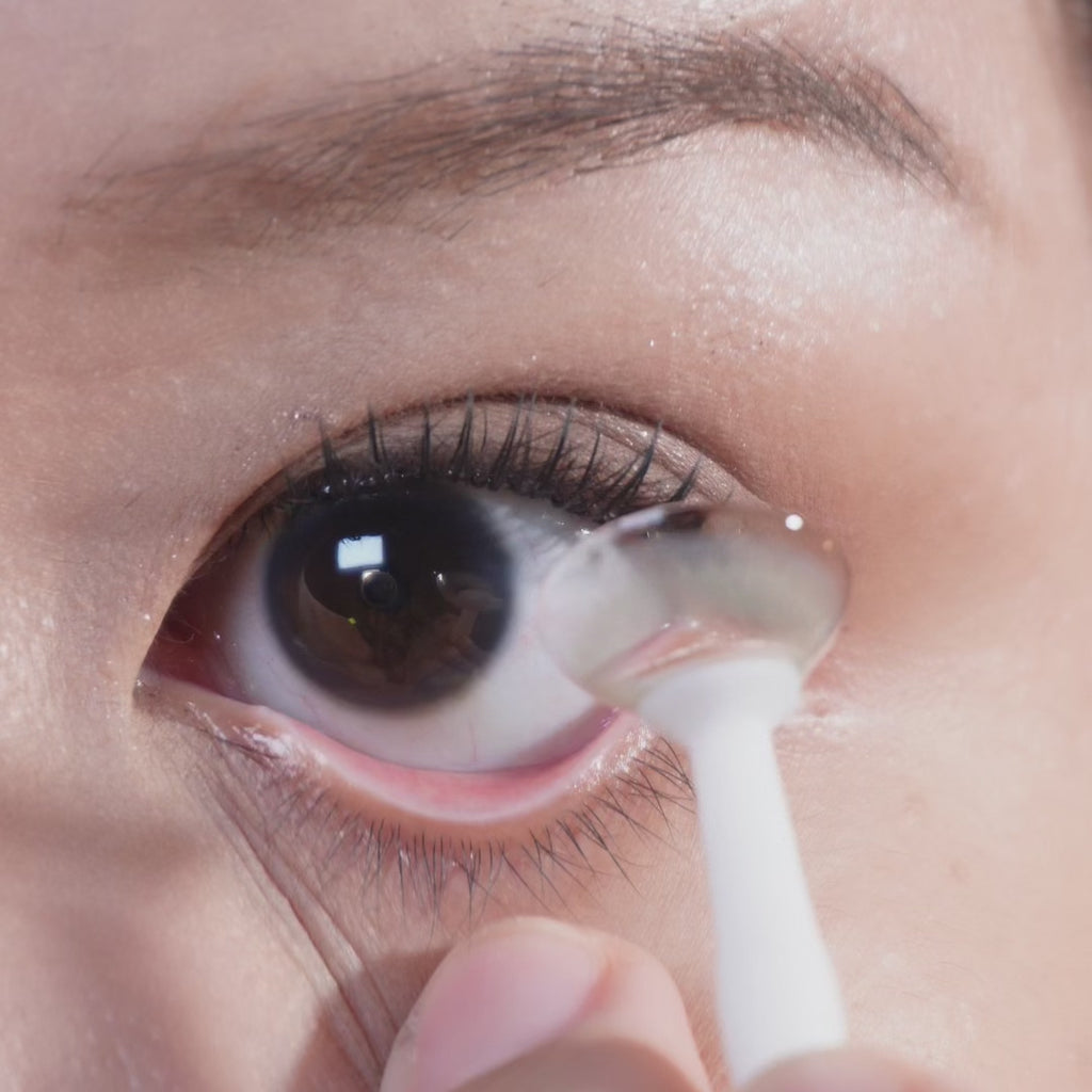 Close up of eye with long lashes blinking, wearing Eyecandys Aura Olive Grey prescription colored contact lenses for a soft natural olive-grey eye enhancement look