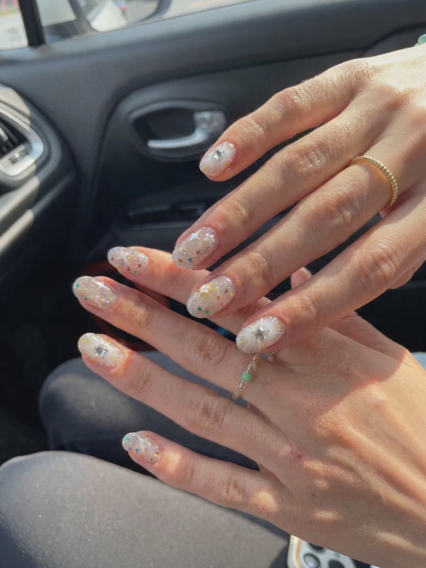 Close-up of hands wearing EyeCandys press-on nails, trendy manicure, reusable nail set, salon-quality nail design.
