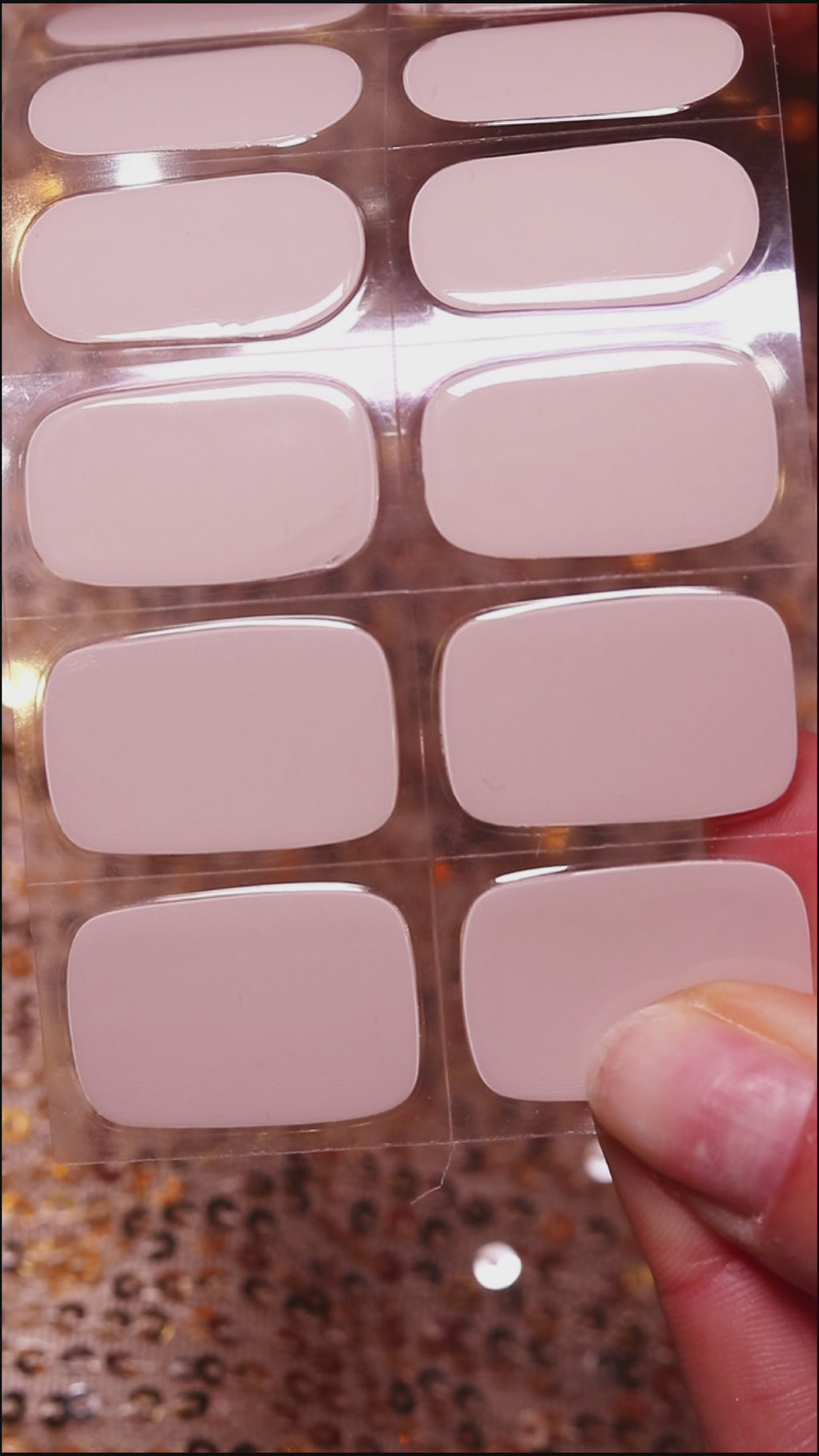 Hand with EyeCandys Nudist Gel nail stickers applied, featuring a chic nude color. Perfect for elegant, minimalist manicures, offering long-lasting wear, easy application, and a smooth, salon-quality gel finish for flawless nails.
