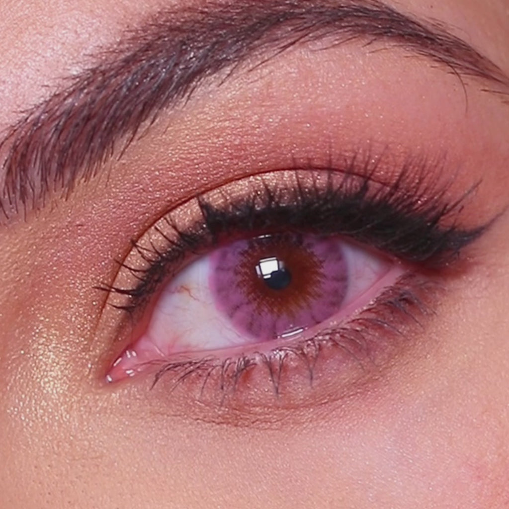 Model wearing EyeCandys Shade Pink colored contact lenses, featuring a soft pink eye transformation with close-up views, natural movement, and a dreamy, doll-like effect on brown eyes.