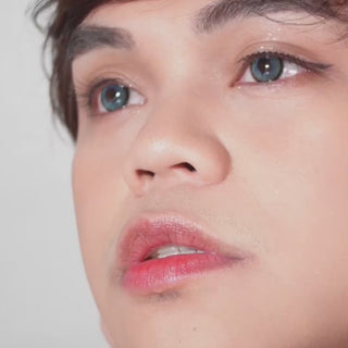 Model wearing EyeCandys Powerglow contact lenses in grey, green, red, and violet — vibrant, full-coverage colors with defined iris limbal rings, UV protection, and moisture-retaining MPC polymer. Perfect for cosplay transformations, showcasing striking eye looks