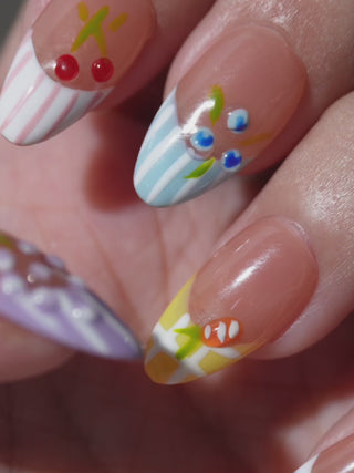 Fresh summer manicure with EyeCandys Macedonia press-on nails featuring fruit nail art and multicolored French tips