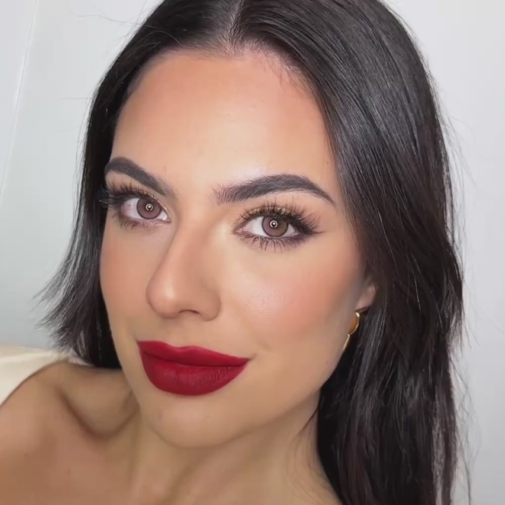 Model wearing EyeCandys Amelie Pink colored contact lenses, showcasing a soft pink eye transformation with close-up views, natural movement, and a bright, romantic look on brown eyes.
