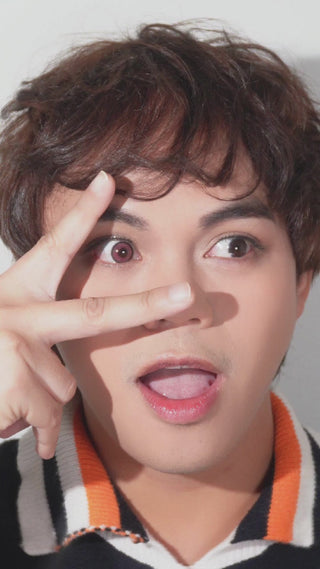 Model wearing EyeCandys Powerglow Red colored contact lenses. Vibrant red color contact lenses perfect for cosplay, with prescription options for a customized fit