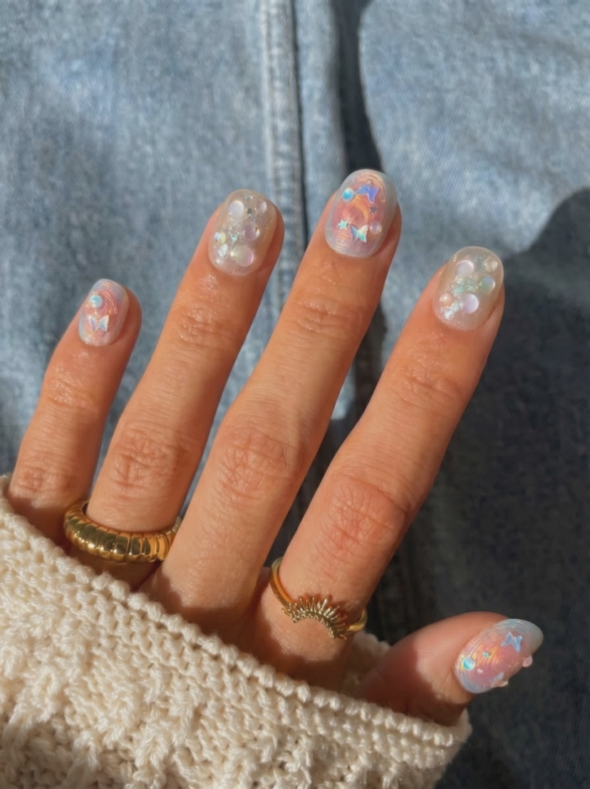 Wearing EyeCandys Love Tomorrow Press-On Nails, warm champagne base with swirling rose gold brushstroke detailing in a short round shape