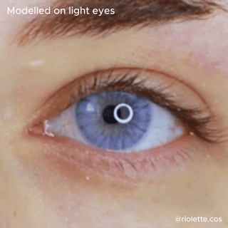 A close-up of a light blue eye wearing EyeCandys Shade Violet Purple contacts that turn the eye brown. "Modelled on light eyes" appears at the top, and "@riolette.cos" is displayed in the bottom right corner.