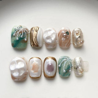 Short square press on nails EyeCandys Shell We with pearl cabochons, silver leaf accents, and textured shell inspired nail design.
