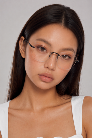 EyeCandys Starlight Rimless Rectangular clear lens glasses model shot featuring rimless rectangular optical frames with non-prescription clear lenses, trendy women's fashion eyewear, prescription-ready glasses, blue light style frames for everyday wear, office outfits, minimalist fashion, and modern luxury looks.