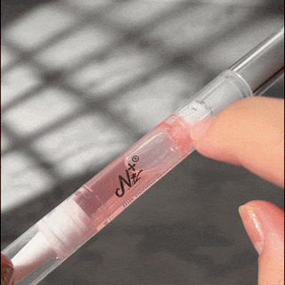 Step nine of removing EyeCandys Gel Nail Stickers: applying oil to gently remove the stickers, ensuring safe removal and maintaining healthy nails for future gel manicures
