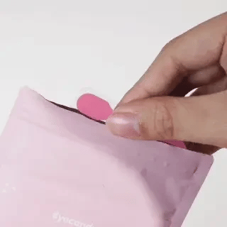 Application of EyeCandys sticky tabs for press-on nails showing step-by-step nail adhesive placement and preparation for secure, long-lasting wear