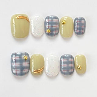 Short round press on nails EyeCandys Study Hall with blue plaid pattern, sage green base, gold line details, and glitter accent nail.