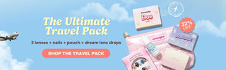 Travel promotion banner featuring the EyeCandys Ultimate Travel Pack with three contact lenses, press-on nails, Dream Eye lubricating drops, a pink travel pouch, a 32% off badge, and a "Shop the Travel Pack" button against a blue sky background.