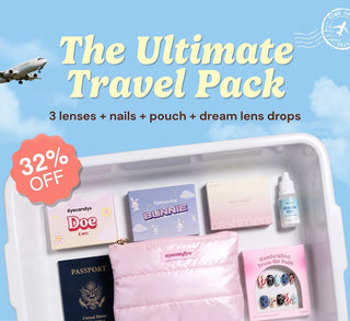 Travel promotion banner featuring the EyeCandys Ultimate Travel Pack with three contact lenses, press-on nails, Dream Eye lubricating drops, a pink travel pouch, a 32% off badge, and a "Shop the Travel Pack" button against a blue sky background.