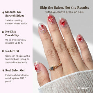 Stylish hand wearing EyeCandys Catching Feelings press on nails featuring romantic jelly nails with heart confetti and star flecks.