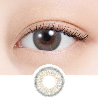 A close-up of a human eye wearing N's Collection Zunda Mochi Green (10pk) colored contact lens by N's Collection for myopia, with the lens design displayed separately below the eye.