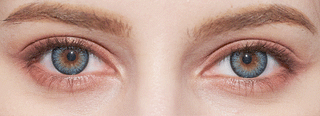 Close-up of a face showcases both eyes—one blue, one brown—with well-groomed eyebrows and natural skin texture, highlighting the striking effect of NEO Vision Cosmo Blue coloured contact lenses from NEO Vision.